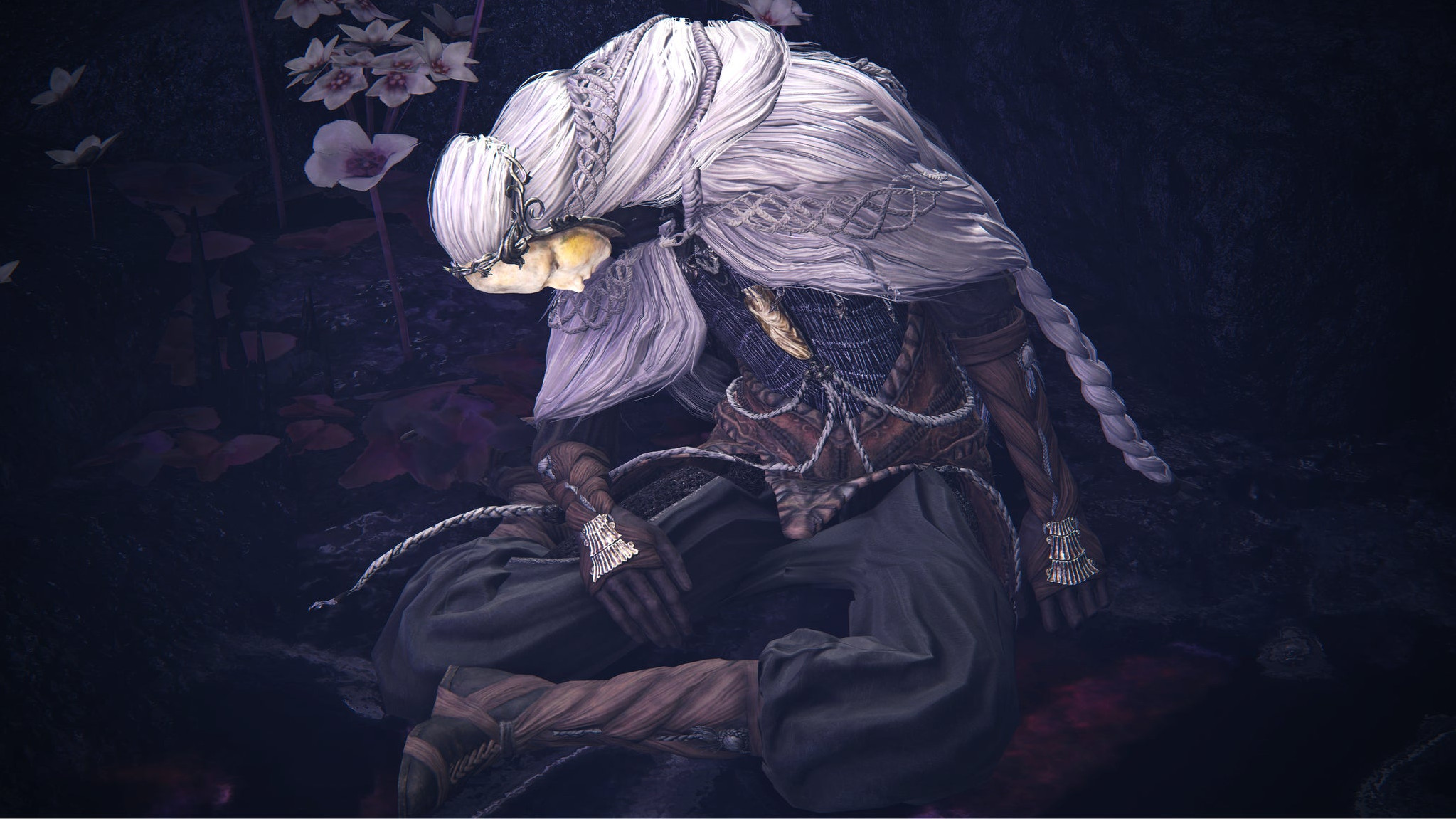 Крупный план Тиолье в Elden Ring: Shadow Of The Erdtree – он ссутулился и почти засыпает.