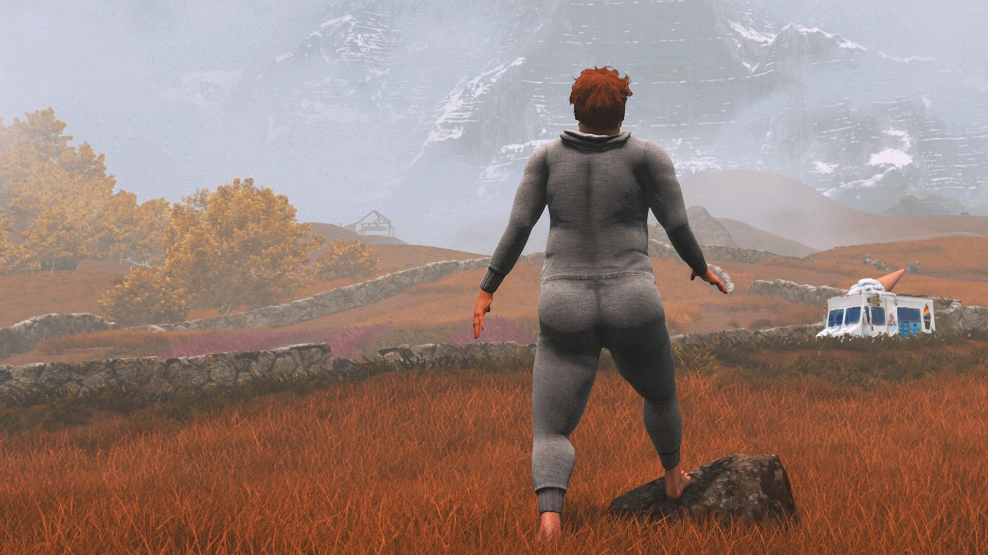 Нейт в сером комбинезоне смотрит на фургон с мороженым и далёкую гору